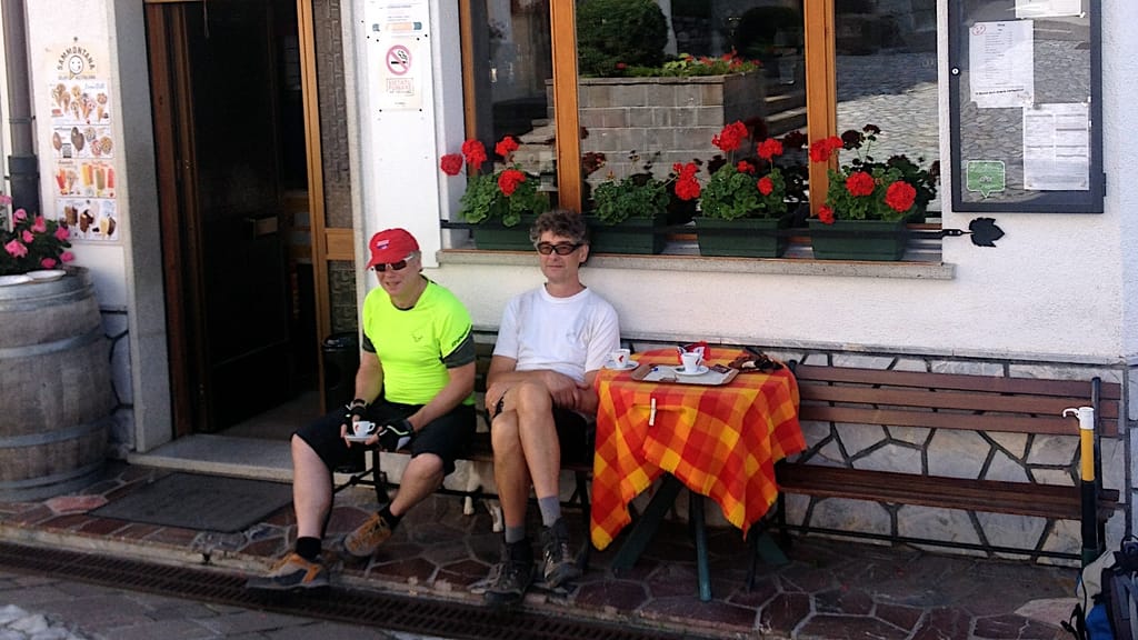 zwei Biker sitzen entspann vor einer Kaffebar